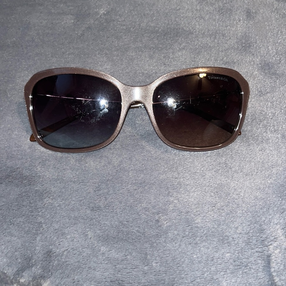 tiffany and co. glasses. glittery brown color. has gold ring on the side